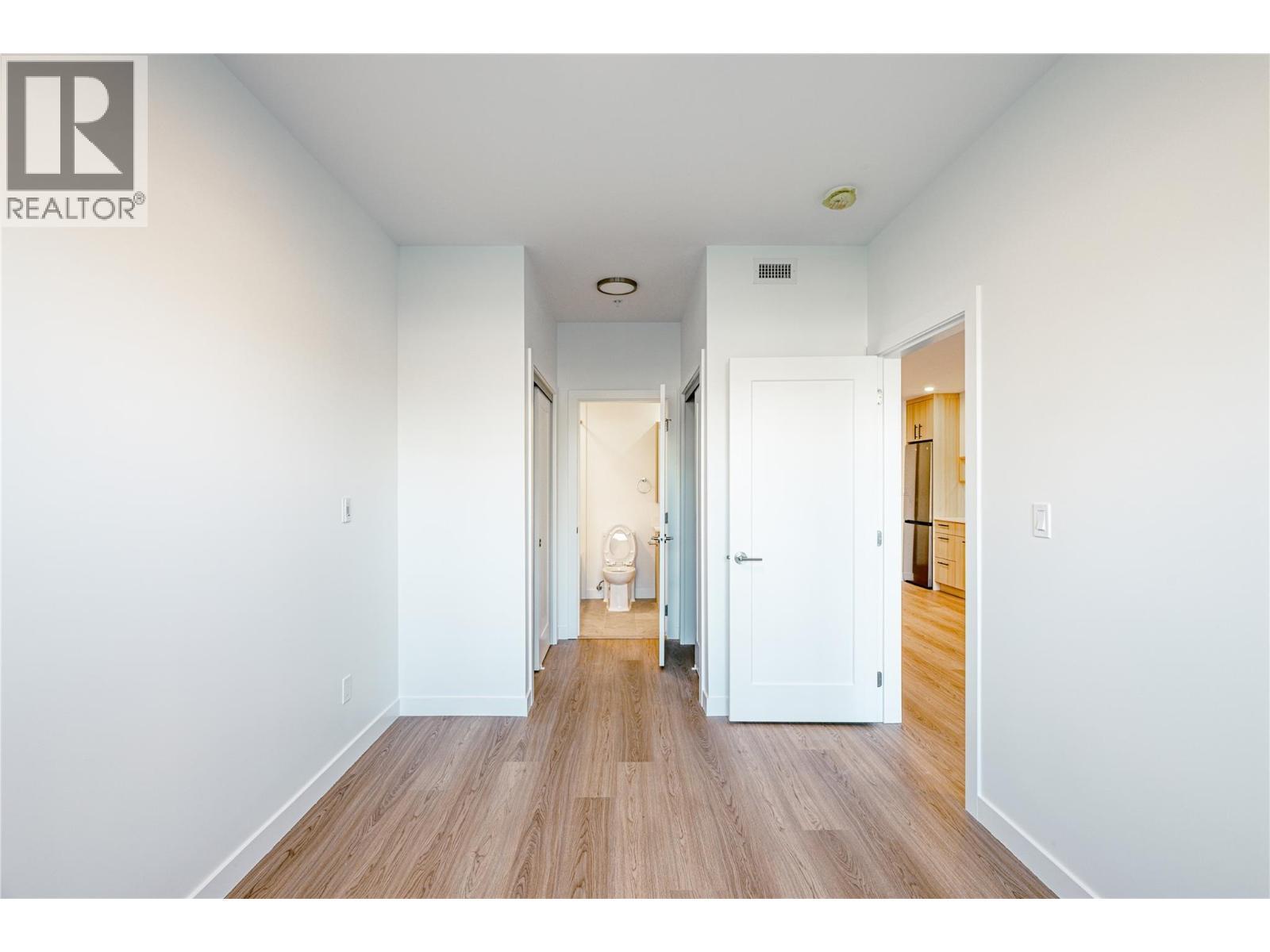 Primary Bedroom, walkthrough closets into bathroom. Photo from similar unit. - 1380 Pridham Avenue Unit# 314, Kelowna, BC - Indoor Photo Showing Other Room