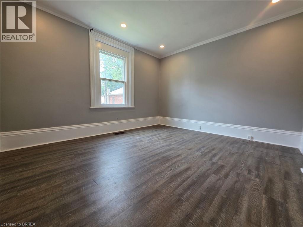 Neutral gray walls with bright white trim and crown molding - 109 Sydenham Street, Brantford, ON - Indoor Photo Showing Other Room