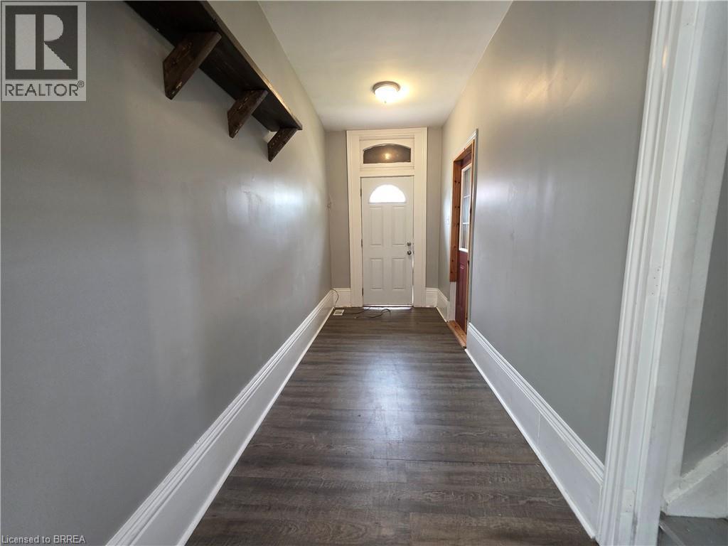 Entryway featuring wood-finish flooring, light gray walls, and white trim - 109 Sydenham Street, Brantford, ON - Indoor Photo Showing Other Room