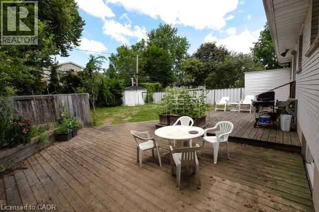 Expansive outdoor deck with wood-finish planks, offering multiple zones for recreation and leisure - 48 Austin Drive Unit# Upper, Waterloo, ON - Outdoor With Deck Patio Veranda
