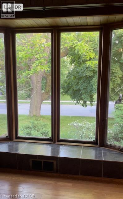 Bay window featuring wood-frame windows, a tiled window seat, and wood-finish flooring - 48 Austin Drive Unit# Upper, Waterloo, ON - Indoor Photo Showing Other Room