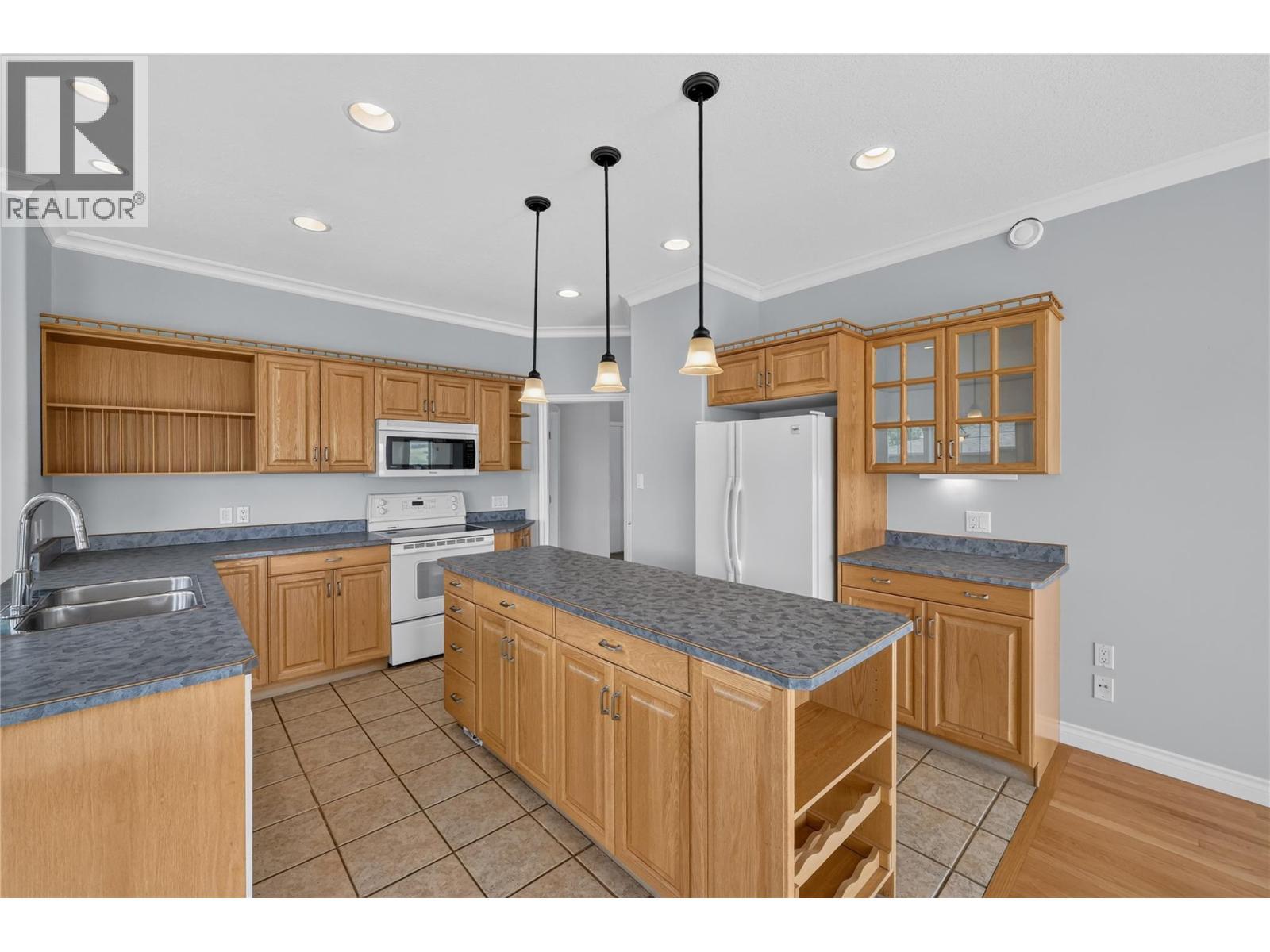 Large kitchen with island, peninsula, and pantry. - 7083 Jasper Drive, Vernon, BC - Indoor Photo Showing Kitchen With Double Sink
