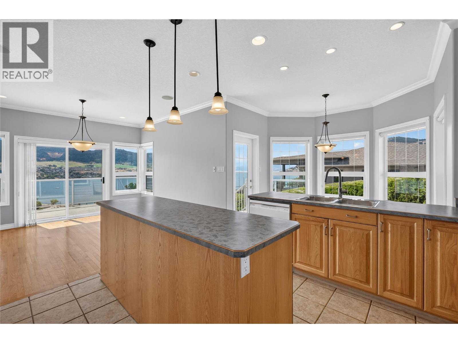Large, eat-in kitchen with nook and full dining room. - 7083 Jasper Drive, Vernon, BC - Indoor Photo Showing Kitchen With Double Sink