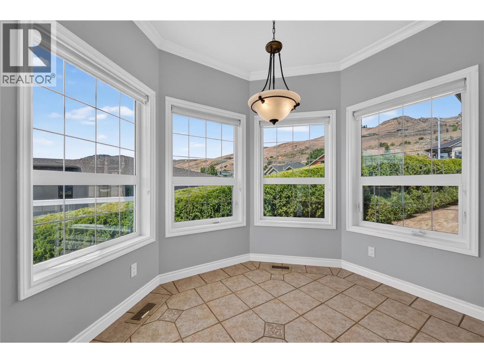 Kitchen nook with lake views. - 7083 Jasper Drive, Vernon, BC - Indoor Photo Showing Other Room