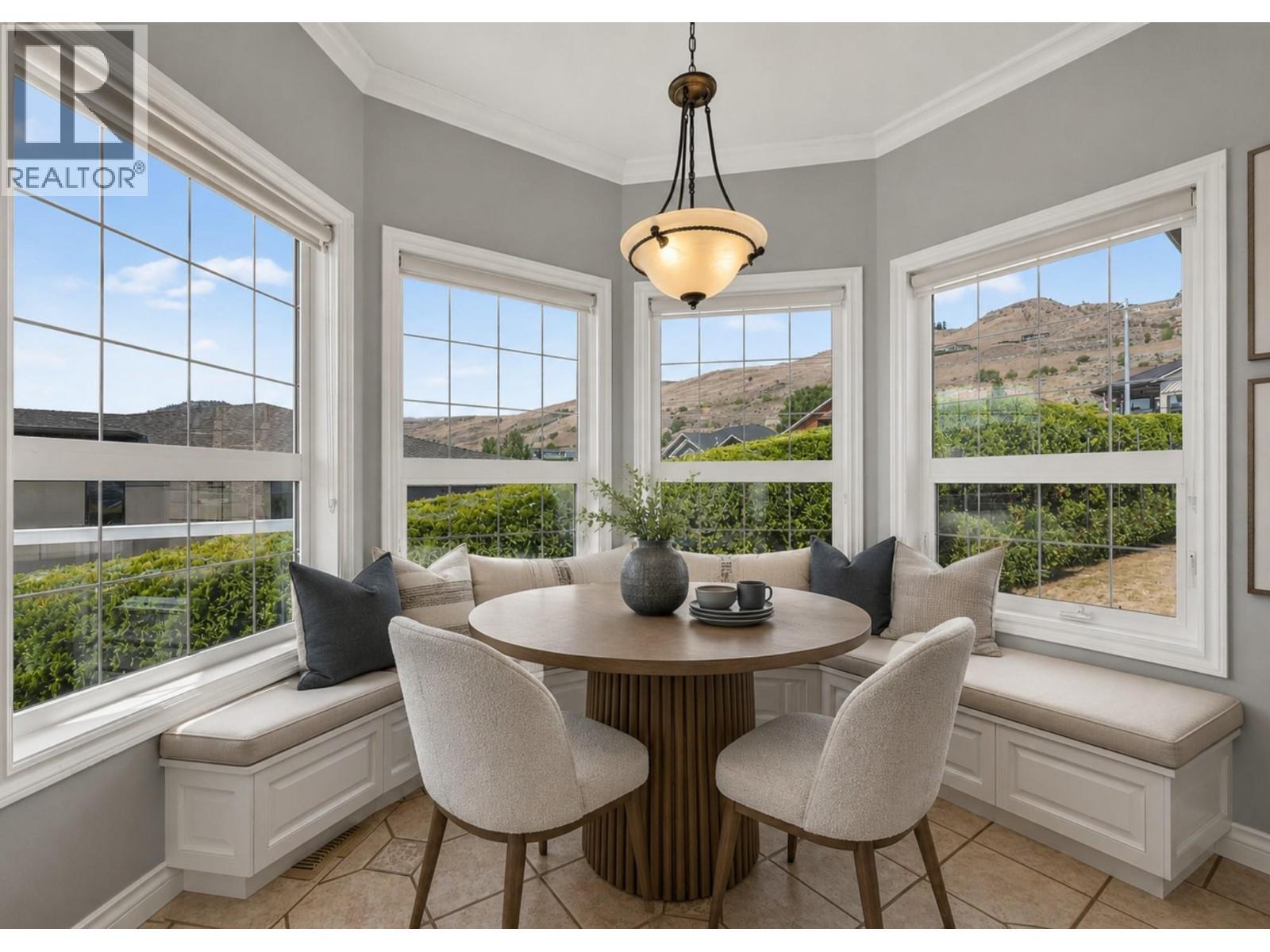 Kitchen nook virtually reimagined with built-in bench and decor. - 7083 Jasper Drive, Vernon, BC - Indoor Photo Showing Dining Room