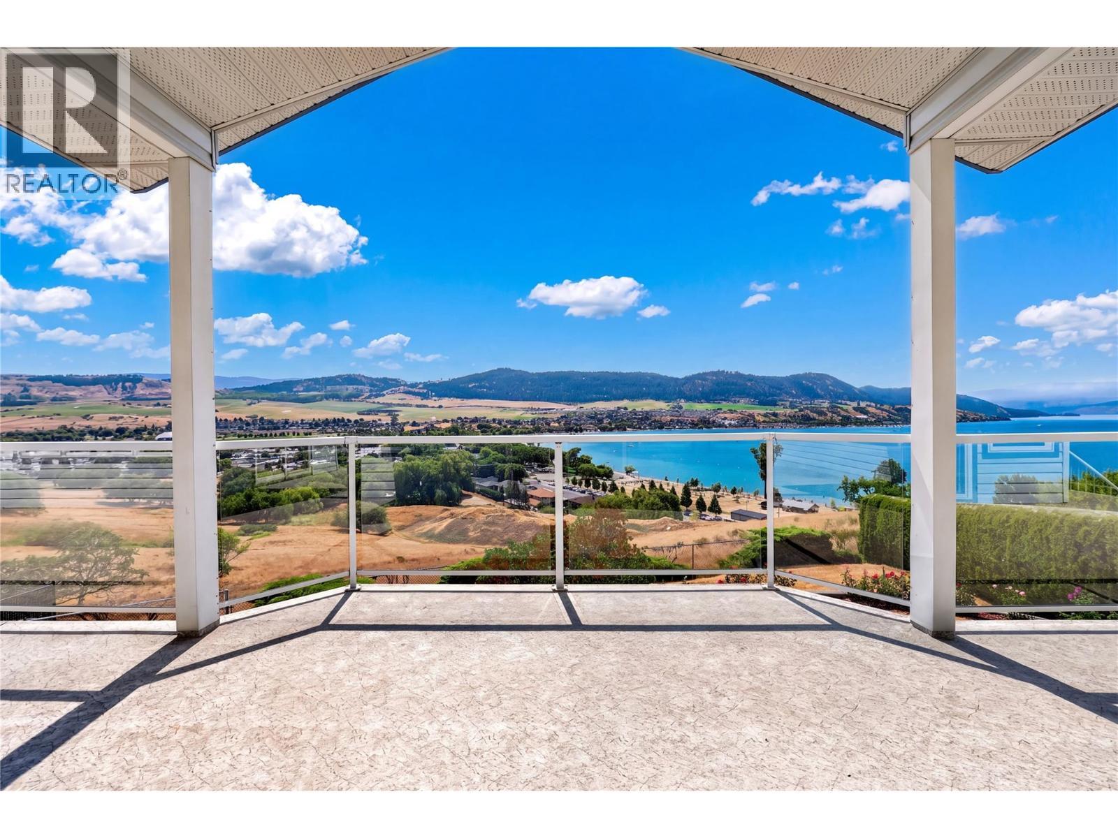 Large covered patio to take in the views. - 7083 Jasper Drive, Vernon, BC - Outdoor With Body Of Water With View