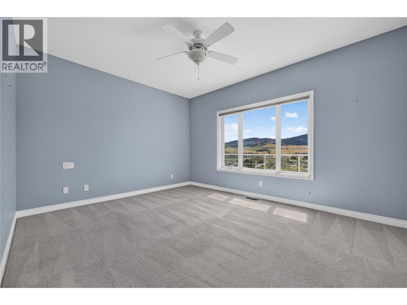 Primary bedroom on main floor. - 7083 Jasper Drive, Vernon, BC - Indoor Photo Showing Other Room