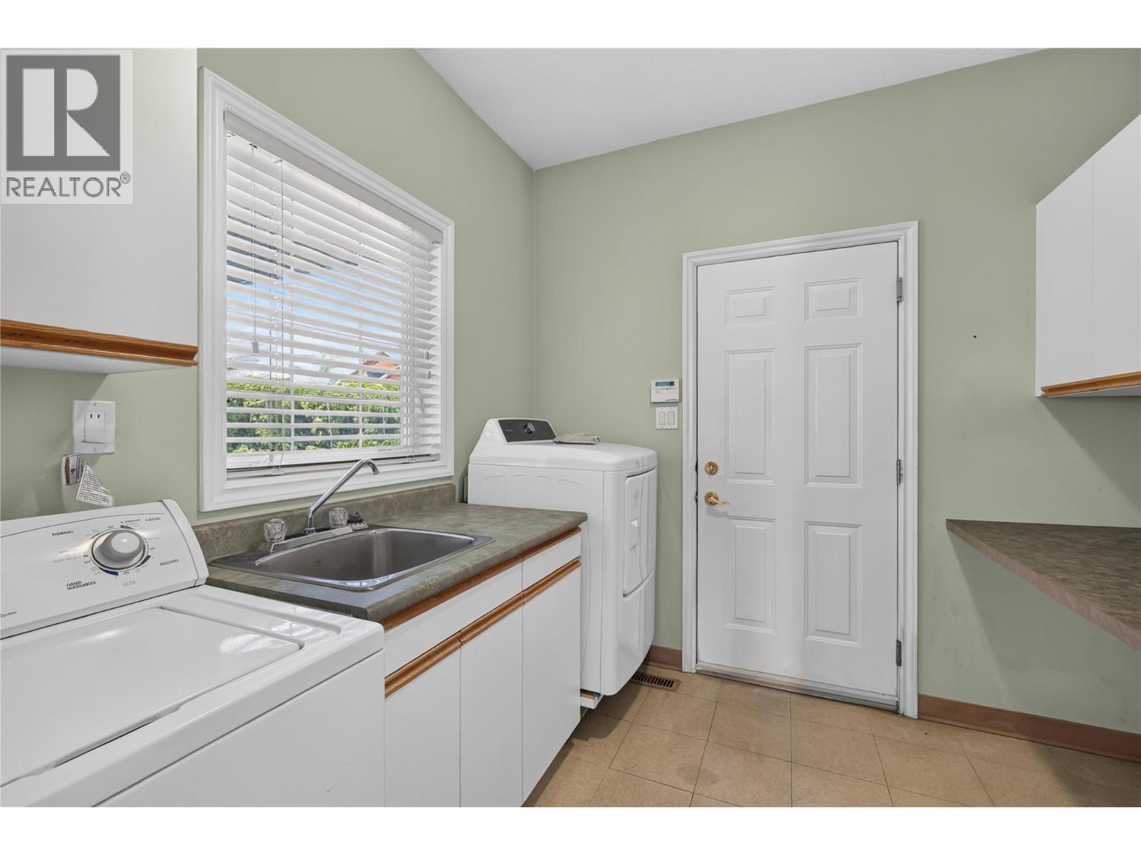 Full laundry/mud room. - 7083 Jasper Drive, Vernon, BC - Indoor Photo Showing Laundry Room
