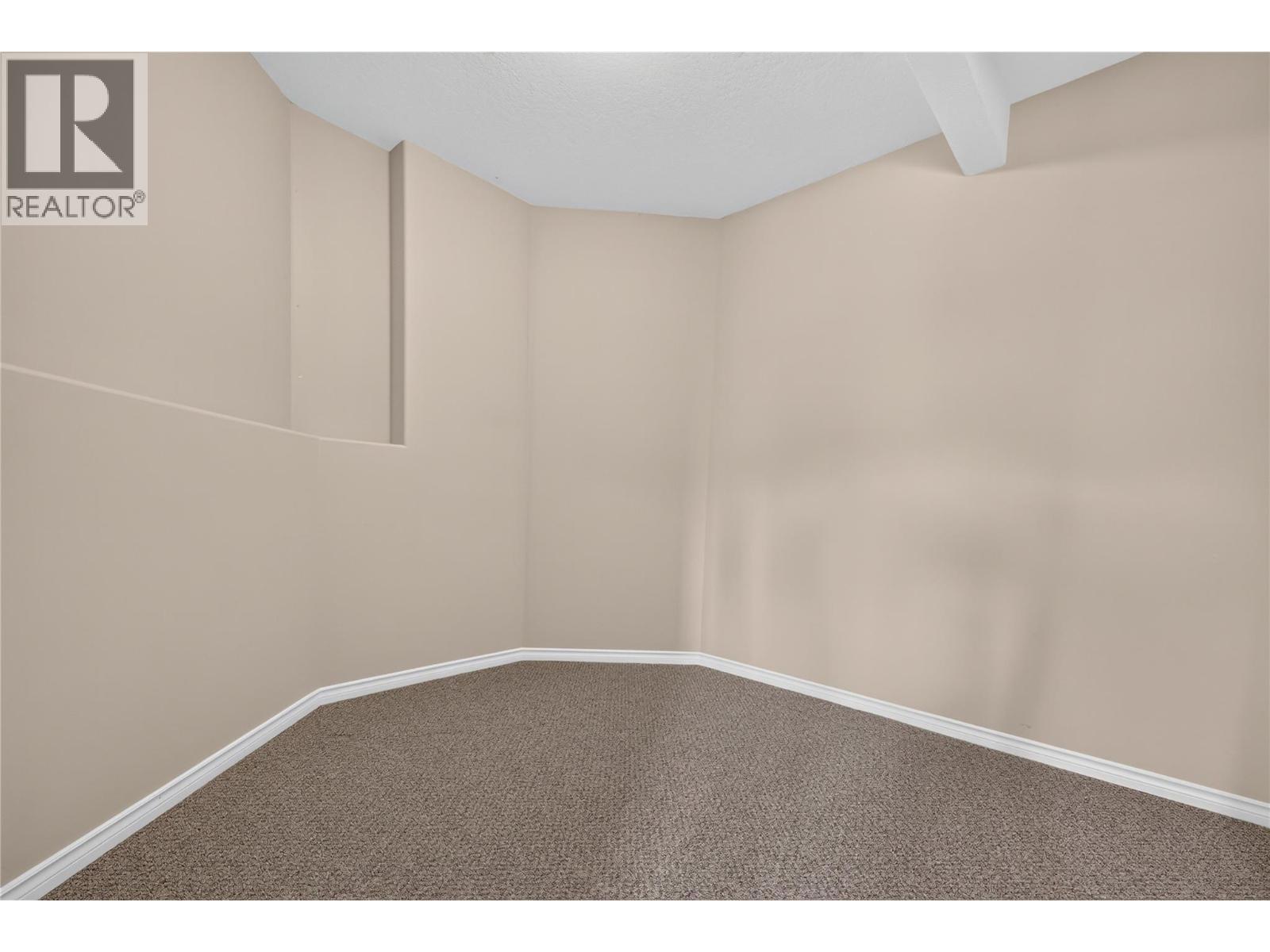 Lower level flex space behind bar room. Perfect for media room, wine tasting room, or man cave. - 7083 Jasper Drive, Vernon, BC - Indoor Photo Showing Other Room
