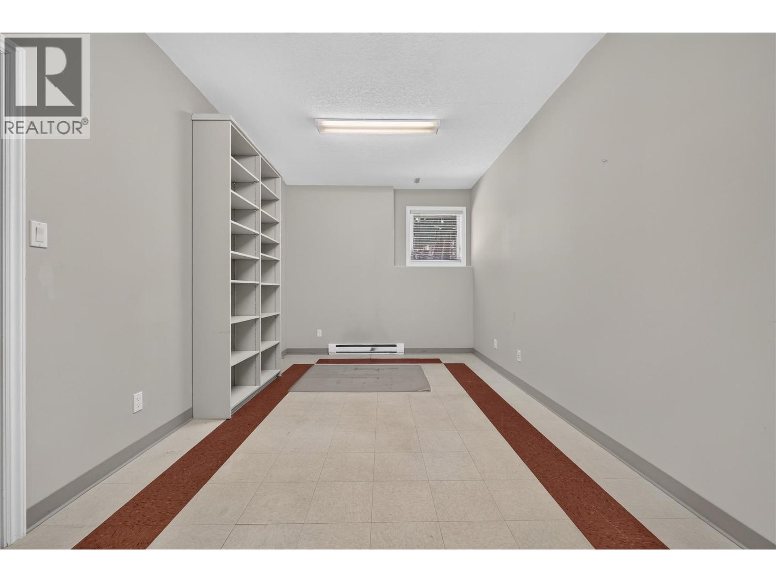 The perfect space for a home-based business. With utility sink, extensive built-in shelving, and ample workspace. - 7083 Jasper Drive, Vernon, BC - Indoor Photo Showing Other Room