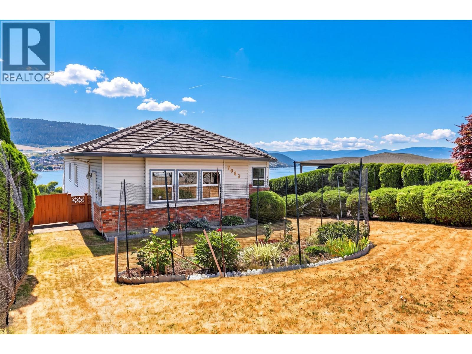 Beautifully landscaped yards with flowers. - 7083 Jasper Drive, Vernon, BC - Outdoor