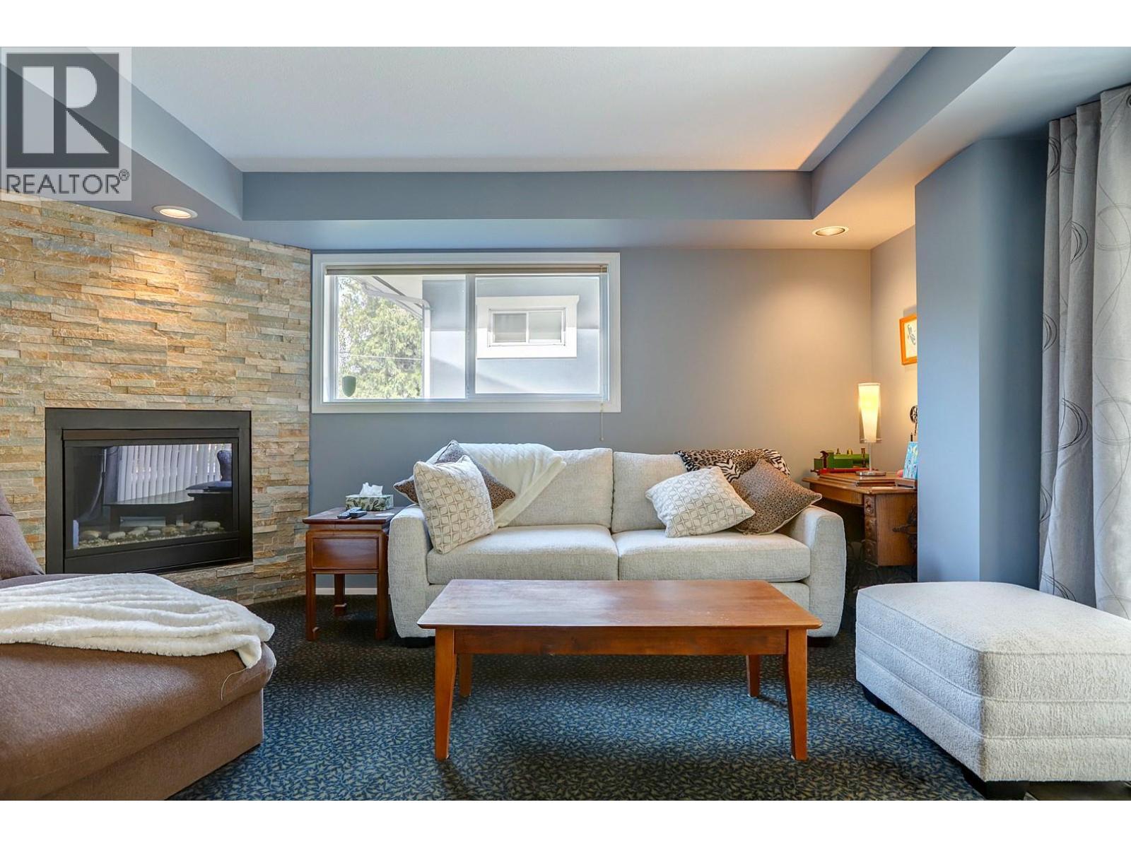 8405 Postill Drive, Coldstream, BC - Indoor Photo Showing Living Room With Fireplace