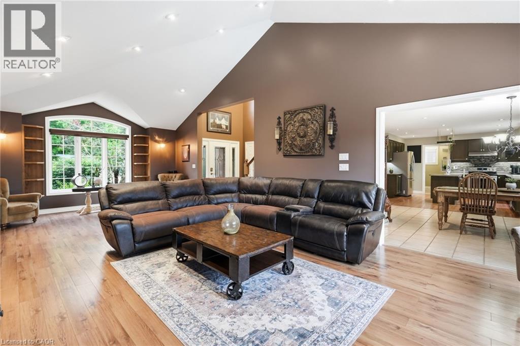 Spacious living area featuring high vaulted ceilings, wood-finish flooring, and recessed lighting - 5 Manor Crescent, Grimsby, ON - Indoor Photo Showing Living Room