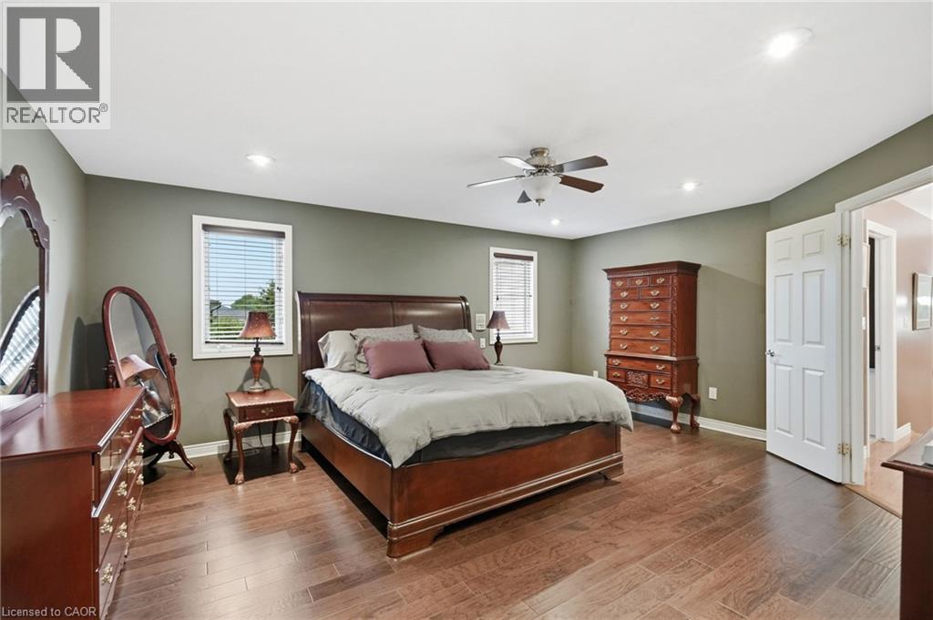 Spacious room featuring wood-finish flooring, recessed lighting, and a ceiling fan - 5 Manor Crescent, Grimsby, ON - Indoor Photo Showing Bedroom