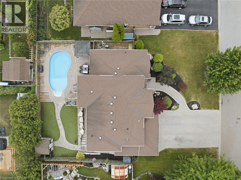 Expansive backyard featuring a kidney-shaped swimming pool, surrounding patio, and dedicated sun deck - 5 Manor Crescent, Grimsby, ON - With In Ground Pool With View