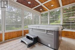Hot tub in a screened Muskoka Room - 