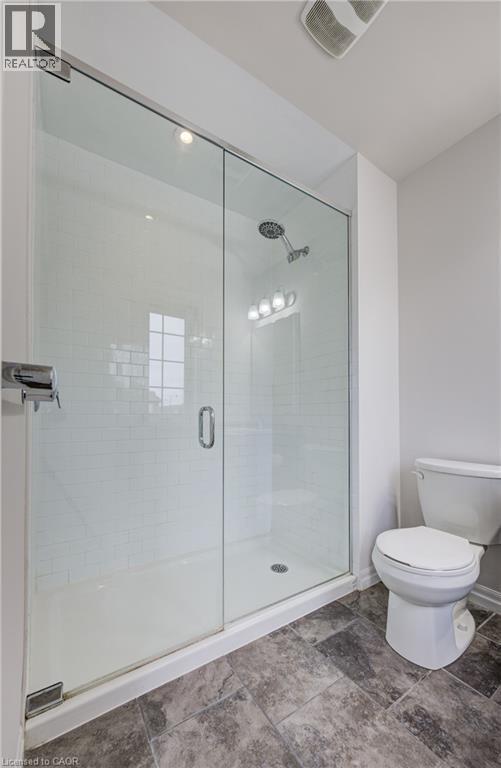 Glass-enclosed shower with white subway tile surround, single showerhead, and recessed lighting - 823 Paris Boulevard, Waterloo, ON - Indoor Photo Showing Bathroom