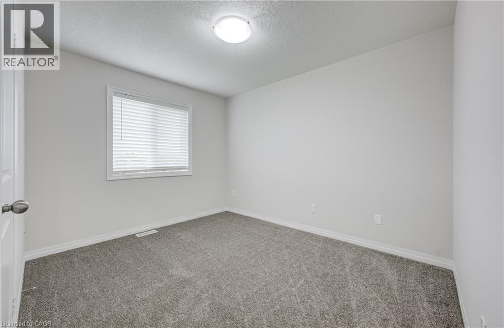 Room featuring light gray carpet, white painted walls, and a single window with blinds - 823 Paris Boulevard, Waterloo, ON - Indoor Photo Showing Other Room