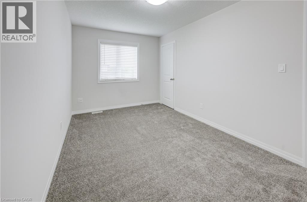 Soft gray carpeting with white baseboards and light-toned walls - 823 Paris Boulevard, Waterloo, ON - Indoor Photo Showing Other Room