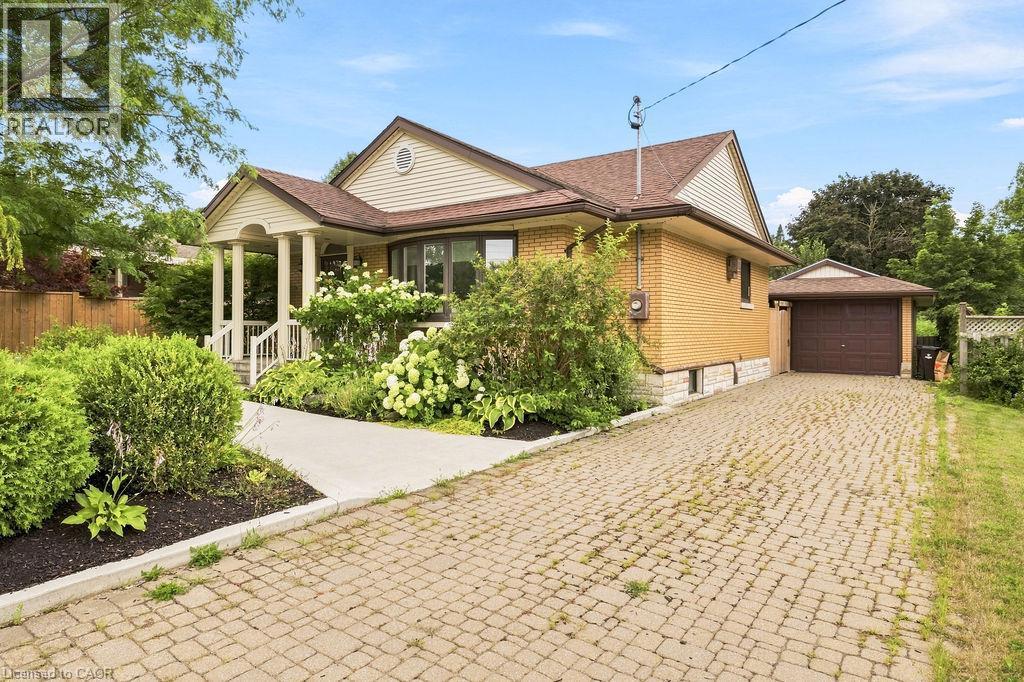 Brick exterior with decorative siding and a covered front porch featuring white columns - 67 Weber Street S, Waterloo, ON - Outdoor
