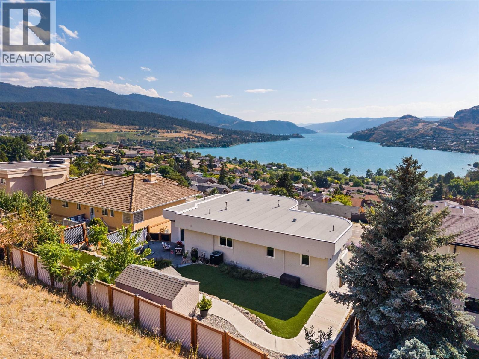 Low maintenance yard with turf in the back. - 759 Middleton Way, Coldstream, BC - Outdoor With Body Of Water With View