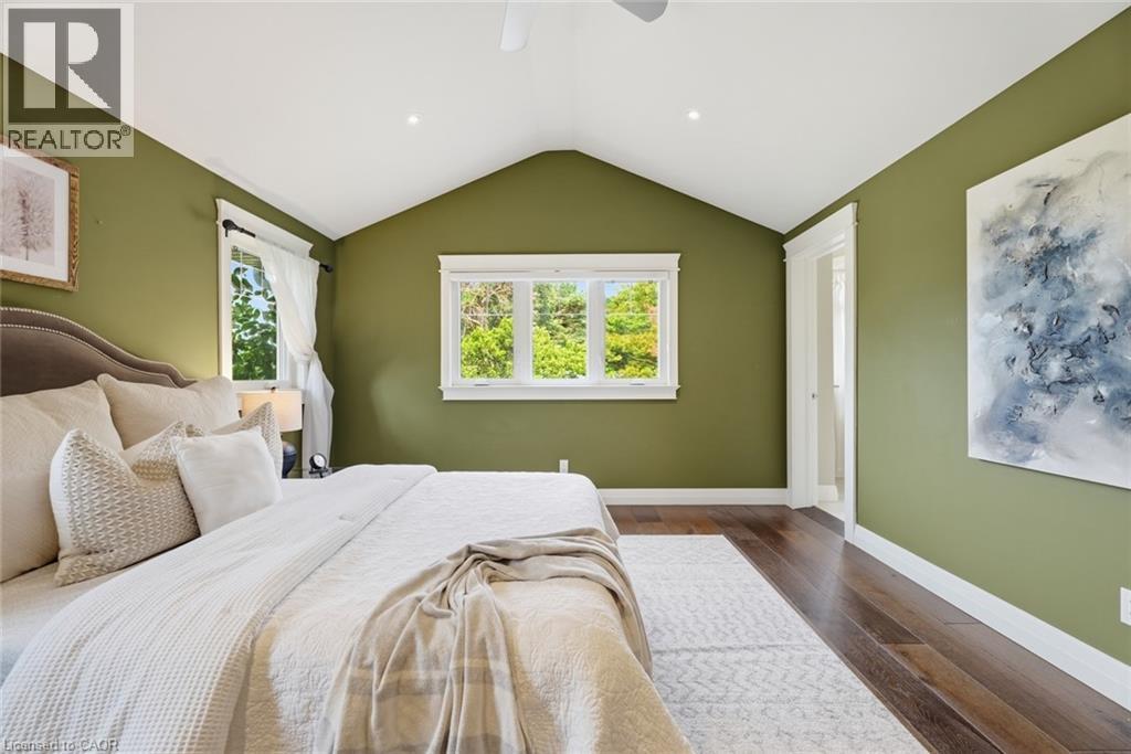 Vaulted ceiling room featuring rich wood-finish flooring and verdant wall tones - 266 Ferndale Place, Waterloo, ON - Indoor Photo Showing Bedroom