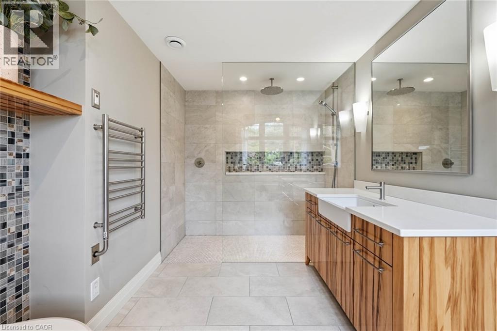 Spacious bathroom featuring a dual vanity with undermount sinks, a large walk-in shower with dual showerheads, and a built-in shower niche with mosaic tile - 266 Ferndale Place, Waterloo, ON - Indoor Photo Showing Bathroom