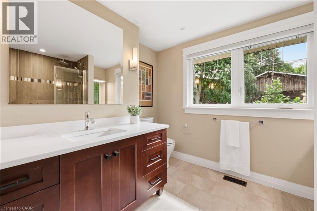 Bathroom vanity with an integrated rectangular sink, white countertop, and chrome faucet - 266 Ferndale Place, Waterloo, ON - Indoor Photo Showing Bathroom