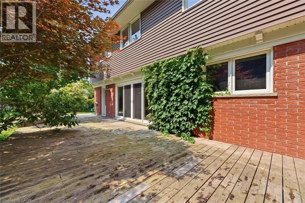 Expansive wood deck with a brick and horizontal siding exterior - 266 Ferndale Place, Waterloo, ON - Outdoor With Deck Patio Veranda With Exterior