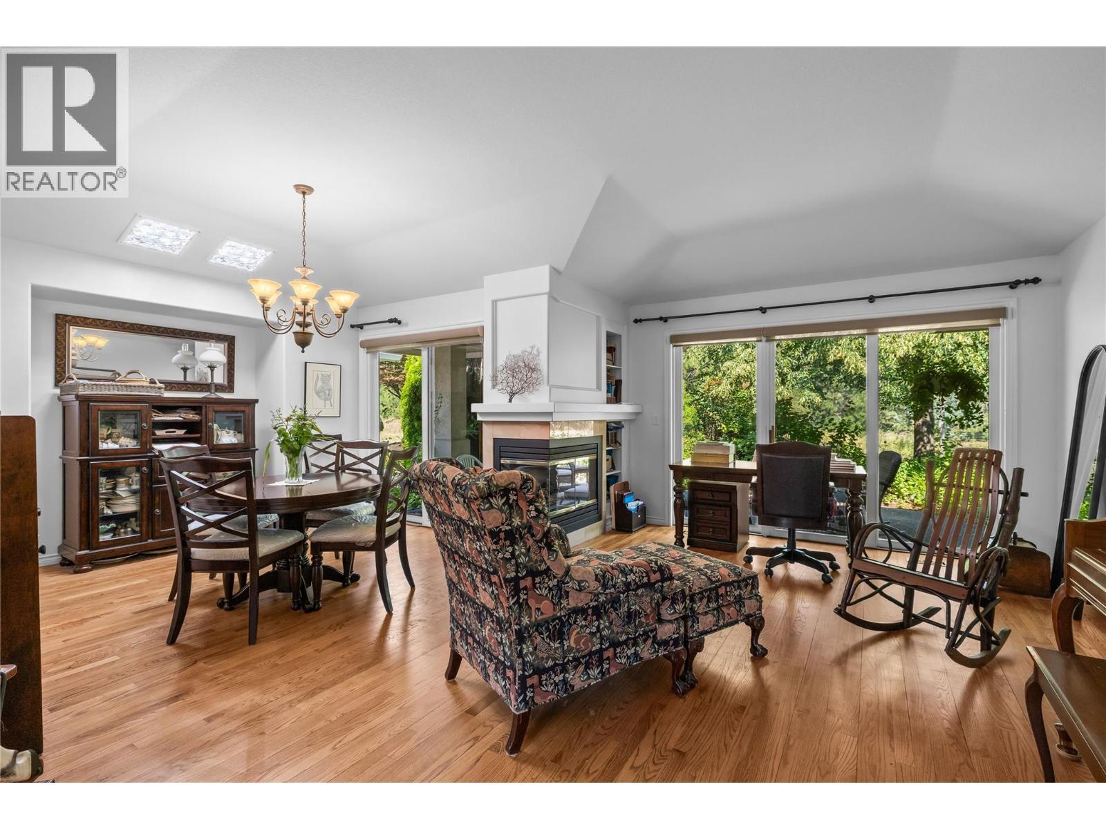 Living Room and Dining Room - 3889 Gallaghers Grange, Kelowna, BC - Indoor With Fireplace
