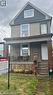 The property features a front porch with brick pillars and a white front door - 219 Avondale Street, Hamilton, ON  - Outdoor With Deck Patio Veranda 