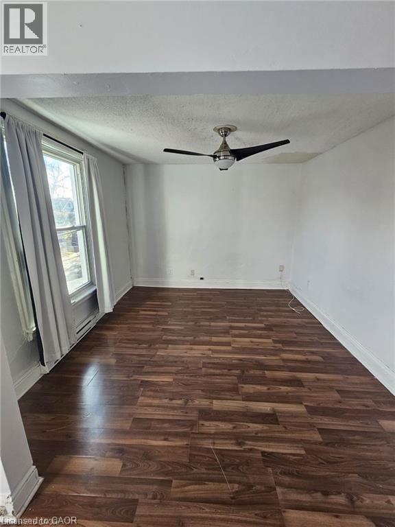 This room features a ceiling fan, a window, and wood-look flooring - 219 Avondale Street, Hamilton, ON - Indoor Photo Showing Other Room