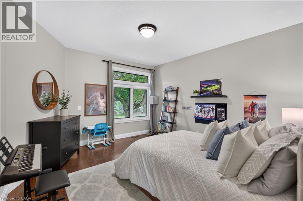 Bedroom featuring a vaulted ceiling and dark wood-finish flooring - 2050 15 Side Road, Milton, ON - Indoor Photo Showing Bedroom