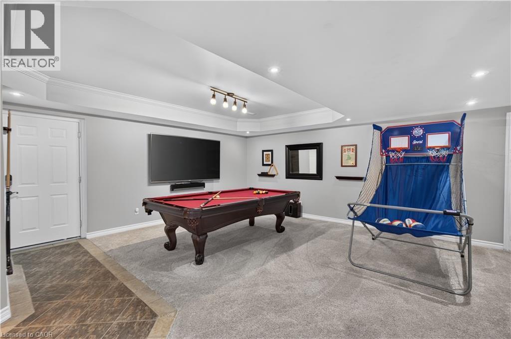 Recessed ceiling lighting, crown molding, and a tray ceiling highlight this finished space - 2050 15 Side Road, Milton, ON - Indoor Photo Showing Other Room