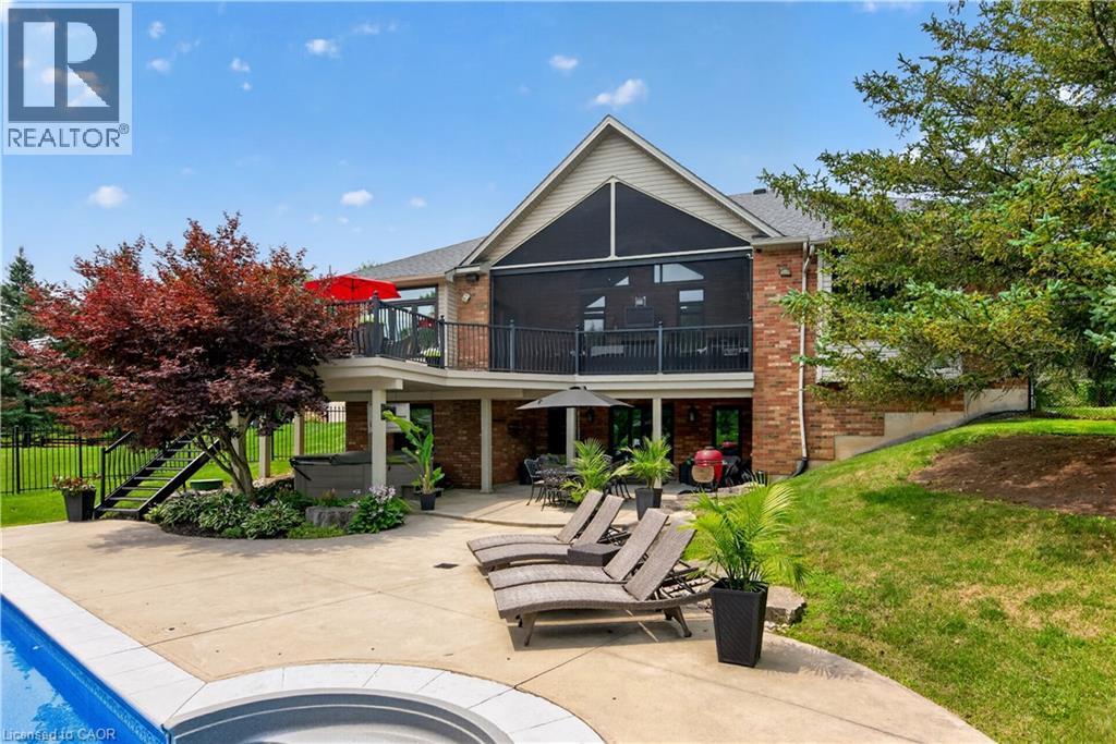 Brick exterior with a screened-in porch and upper-level balcony - 2050 15 Side Road, Milton, ON - Outdoor