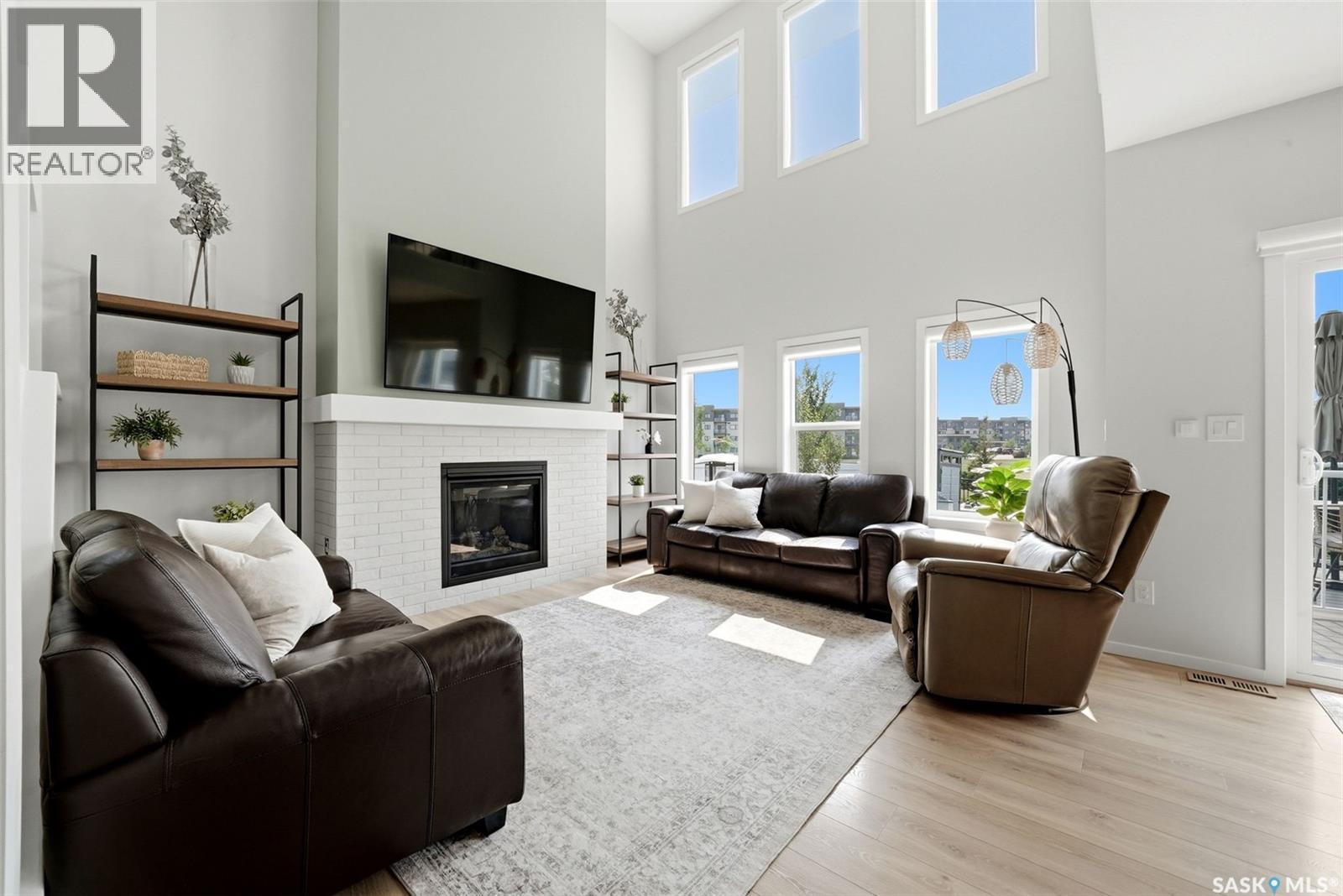 5209 E Green Crescent, Regina, SK - Indoor Photo Showing Living Room With Fireplace