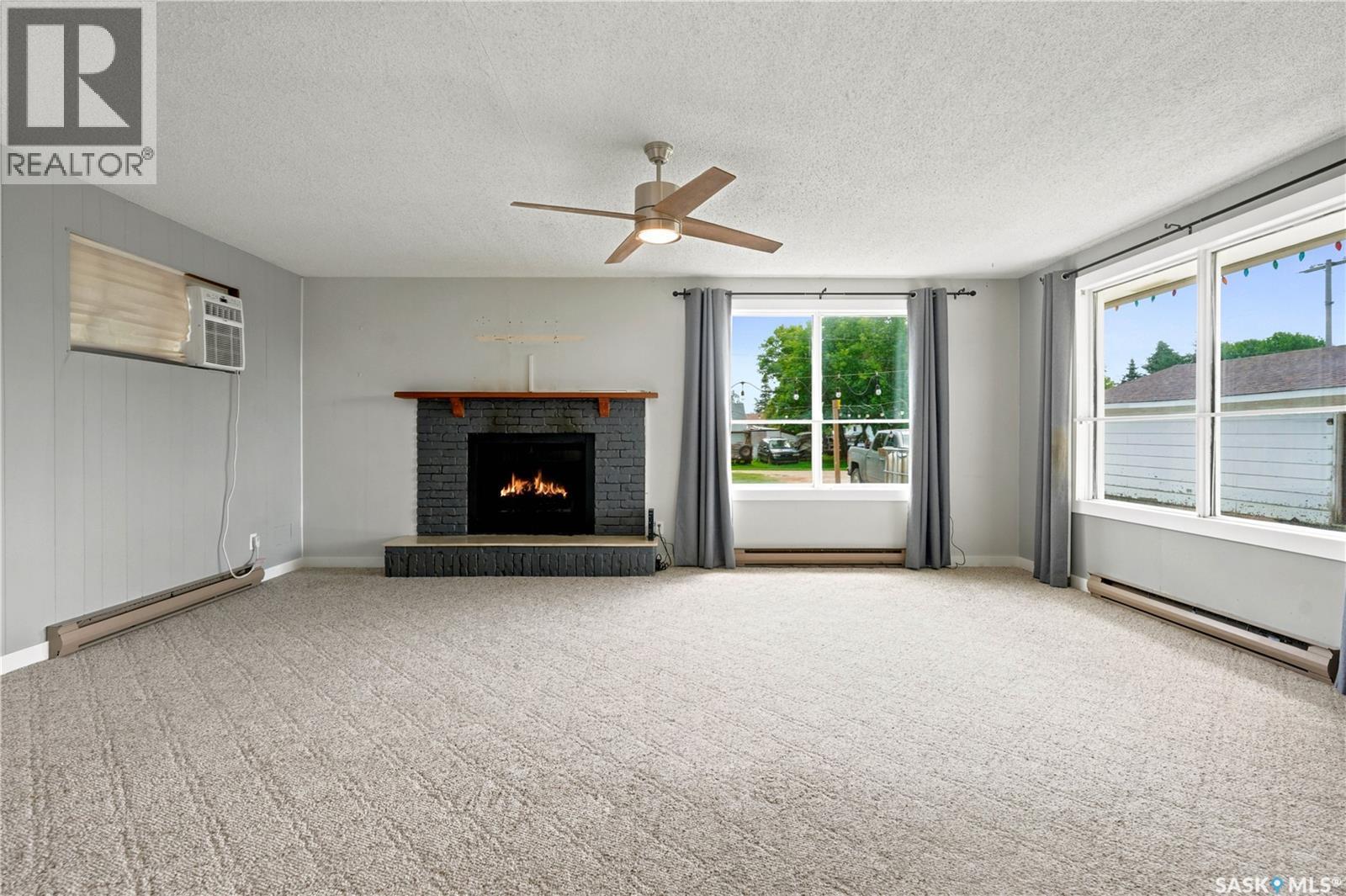 54 Hill Street, Eyebrow, SK - Indoor Photo Showing Living Room With Fireplace