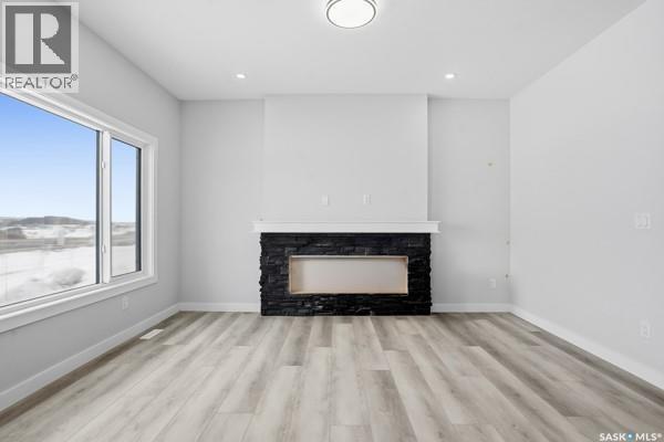 783 Nazarali Union, Saskatoon, SK - Indoor Photo Showing Living Room With Fireplace