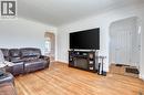Warm wood-finish flooring complements light-toned walls in this living space - 27 Delevan Crescent, Hamilton, ON  - Indoor Photo Showing Living Room 