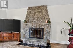 Stone faced wood fireplace in living room - 