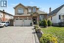 Two-story residence featuring brick and stucco facade, a two-car garage, and an imprinted concrete driveway - 284 Normanhurst Avenue, Hamilton, ON  - Outdoor With Facade 