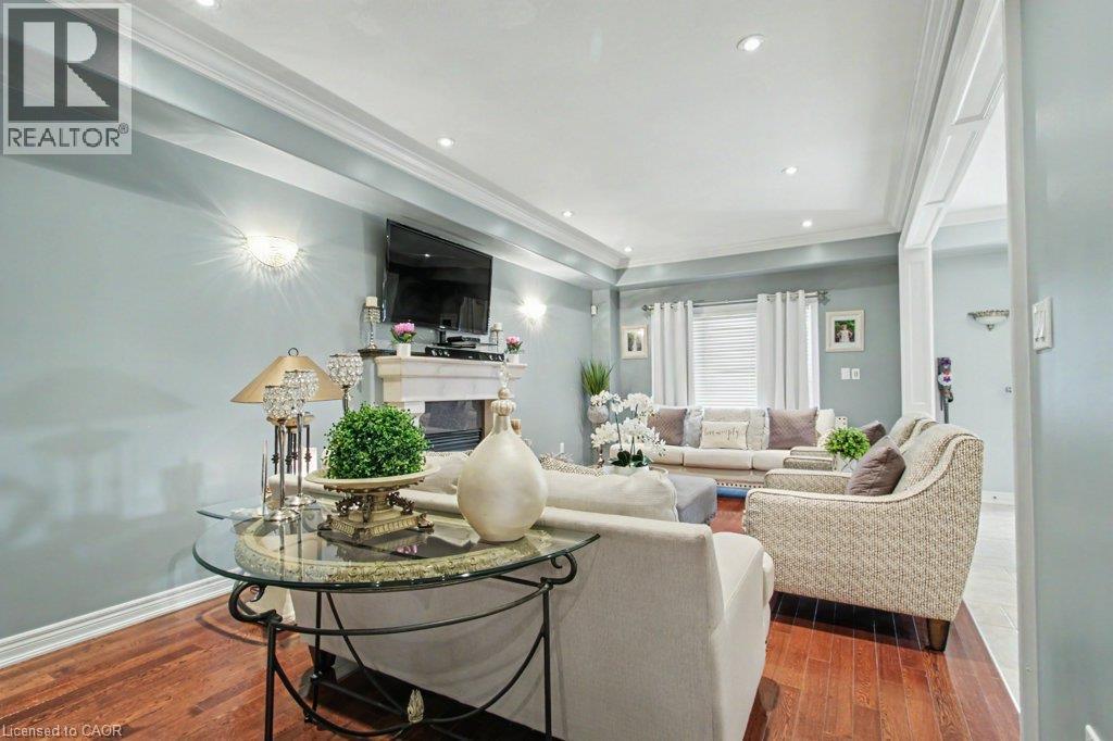 Living area featuring wood-finish flooring, recessed lighting, crown molding, and a fireplace with a mantel - 284 Normanhurst Avenue, Hamilton, ON - Indoor