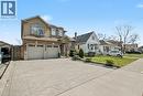 Stucco and brick facade residence featuring a two-car garage, concrete driveway, and front landscaping - 284 Normanhurst Avenue, Hamilton, ON  - Outdoor With Facade 