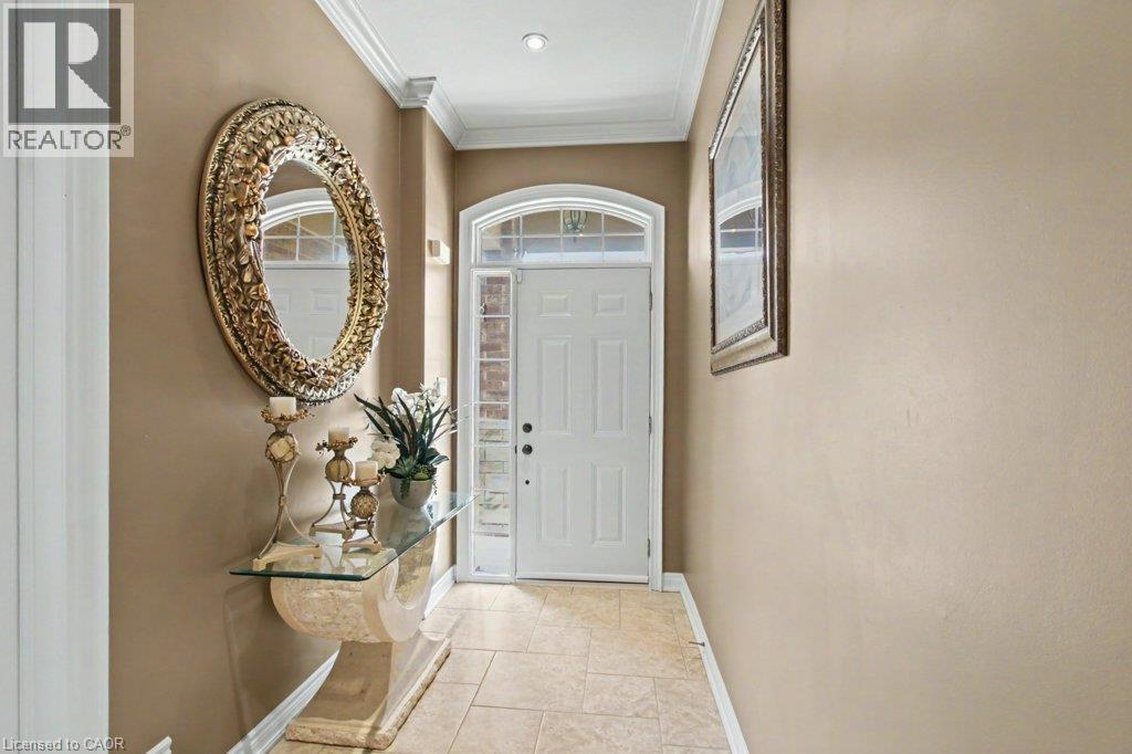 Entryway featuring a white paneled door with an arched transom, sidelight windows, and tile flooring - 284 Normanhurst Avenue, Hamilton, ON - Indoor Photo Showing Other Room