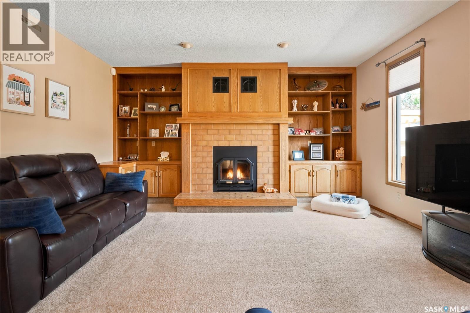 6112 Brunskill Place, Regina, SK - Indoor Photo Showing Living Room With Fireplace