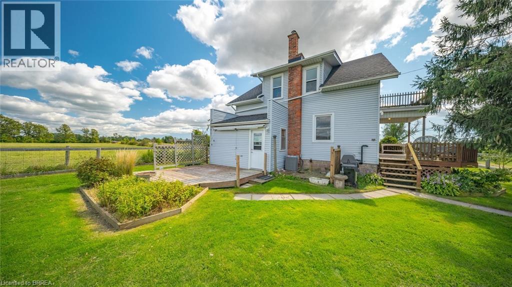Expansive green lawn surrounds a multi-level outdoor living space - 3211 Highway 3, Jarvis, ON - Outdoor