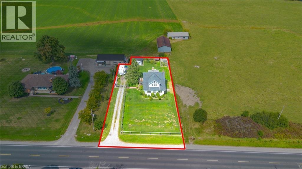 Gabled residence on a large grass lot with a gravel driveway - 3211 Highway 3, Jarvis, ON - Outdoor With View