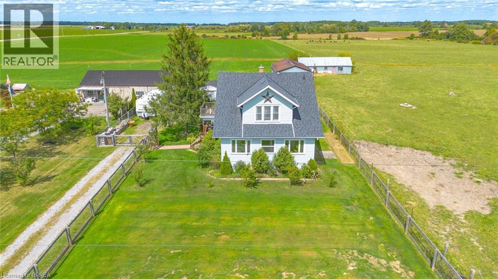 Light blue exterior with white trim, featuring a dark shingle roof and a prominent front gable - 3211 Highway 3, Jarvis, ON - Outdoor With View