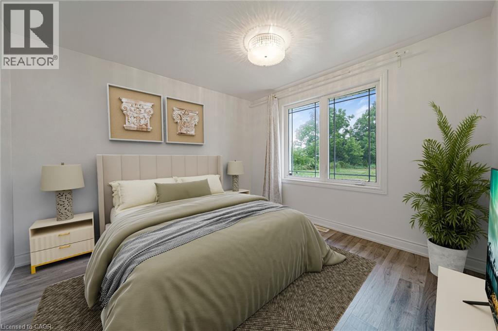 Bedroom featuring a large window with white trim, wood-finish flooring, and a contemporary ceiling light fixture - 7332 Twenty Road E, Glanbrook, ON - Indoor Photo Showing Bedroom