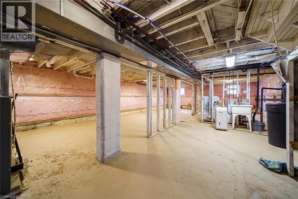 Unfinished basement with concrete flooring and exposed ceiling joists - 7332 Twenty Road E, Glanbrook, ON - Indoor Photo Showing Basement